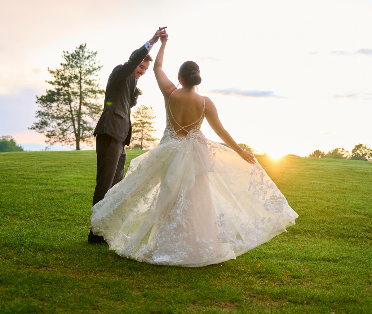 bride and groom dancing outside at sunset