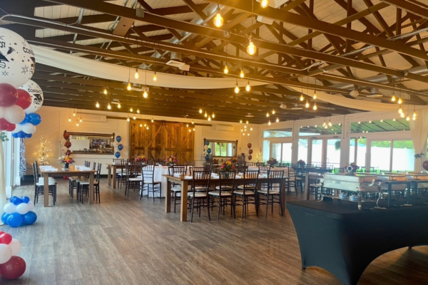 The Farmhouse reception room with blue, red, and white balloons
