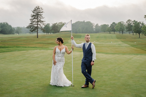 Couple posing on the green at the Candia Woods Golf Links