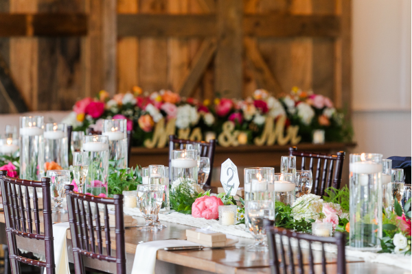 Up-close view of a table setting at the Farmhouse with bright florals