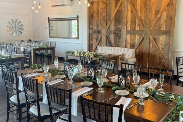 Table setting with white linens and greenery in the Farmhouse