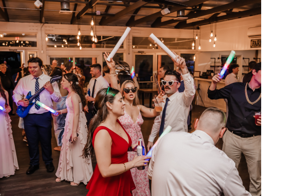 Wedding guests dancing at a wedding reception inside at The Farmhouse